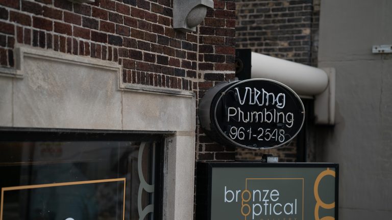 Viking Plumbing's exterior neon sign during the daytime.